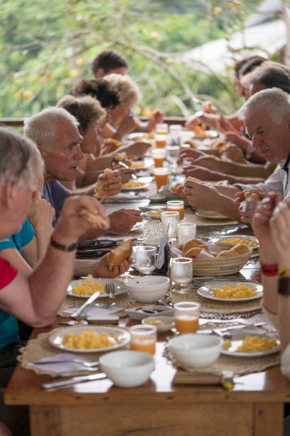 istock Tourists having breakfast at one table at hostel in Misahualli, Ecuador 1202088060