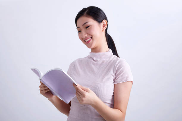 istock young chinese woman reading book 1202088324