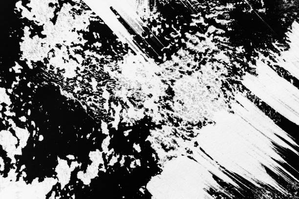 istock Patterns of white paint from a brush on a black background 1202088606