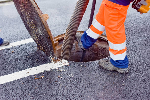 istock workers cleaning and maintaining the sewers on the roads 1202088683