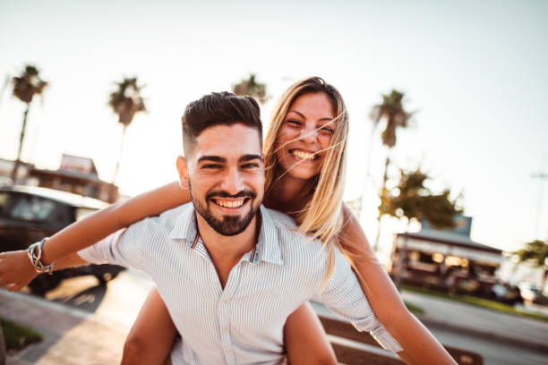 istock piggybacking couple at dusk on vacation 1202088849