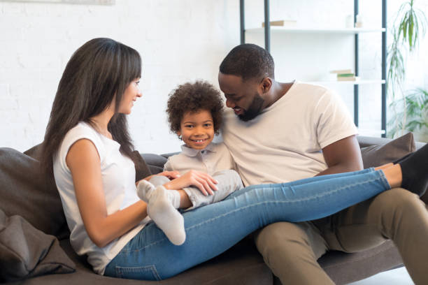 istock Smiling parents playing with their little son at home 1202088902