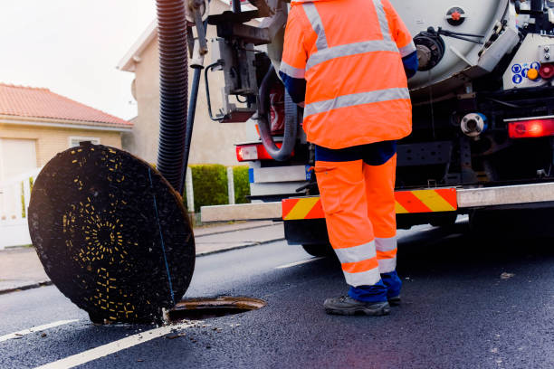 istock workers cleaning and maintaining the sewers on the roads 1202089621