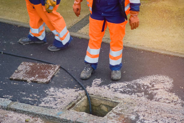 istock workers cleaning and maintaining the sewers on the roads 1202089821