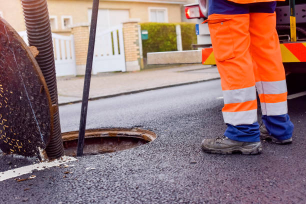 istock workers cleaning and maintaining the sewers on the roads 1202089882