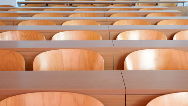 istock Empty seats in new modern clean lecture hall or classroom 1202090579