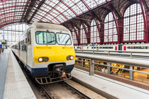 istock Electric locomotive pulling a passenger train standing in a station 1202091216