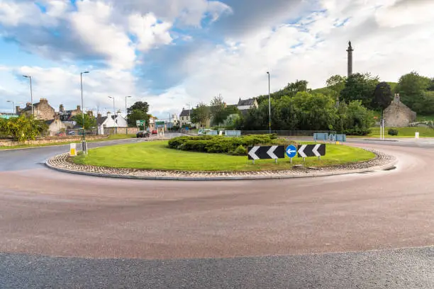 View of a roundabout in a urban setting on a cloudy spring day. Elgin, Scotland, UK.