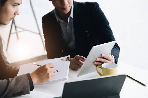 istock Businessman and partner hand using digital tablet and making presentation business strategy. 1202091289