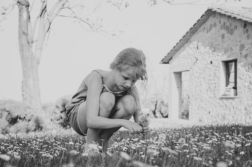 adorable little child in floral meadow in Tuscany monochrome