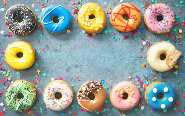 istock Festive carnival or birthday frame from various colourful donuts 1202092027