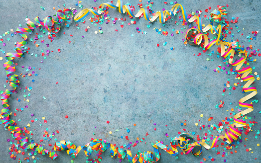 Festive carnival or birthday party background with colorful streamers and confetti