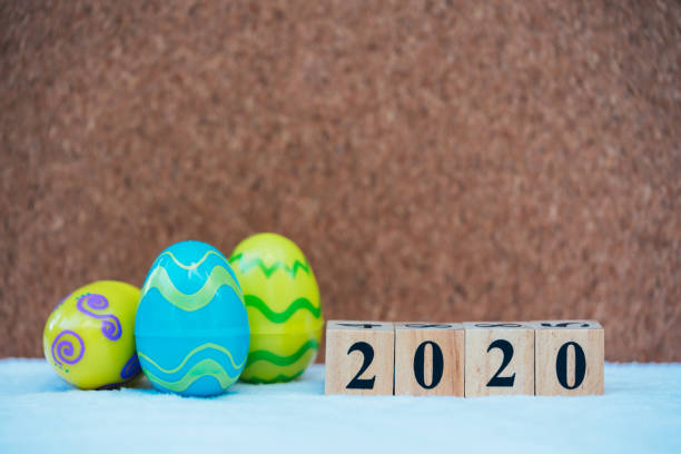 istock Word text blocks 2020 with colorful easter eggs background. Festive decoration. 1202092097