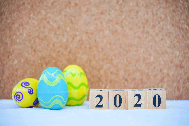 Word text blocks 2020 with colorful easter eggs background. Festive decoration. stock photo