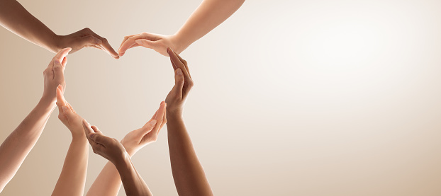 Symbol and shape of heart created from hands.The concept of unity, cooperation, partnership, teamwork and charity.