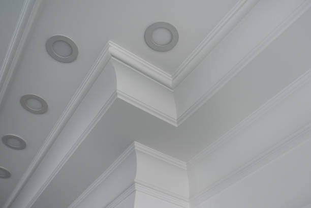 istock Ceiling moldings in the interior, detail of a angular ceiling skirting and lamps 1202093116