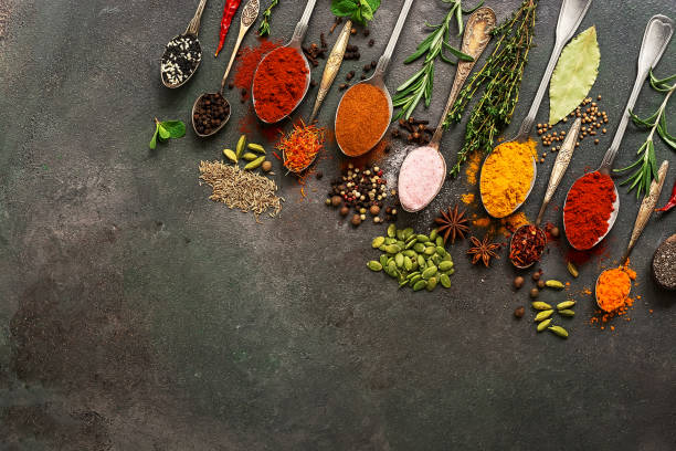 istock A variety of spices, herbs, seeds in a spoon on a dark painted rustic background. Assorted colored different seasonings. Flat lay,view from above, corner frame. 1202093235