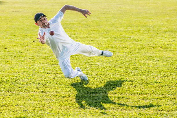 istock Cricket player trying to catch the ball 1202097471