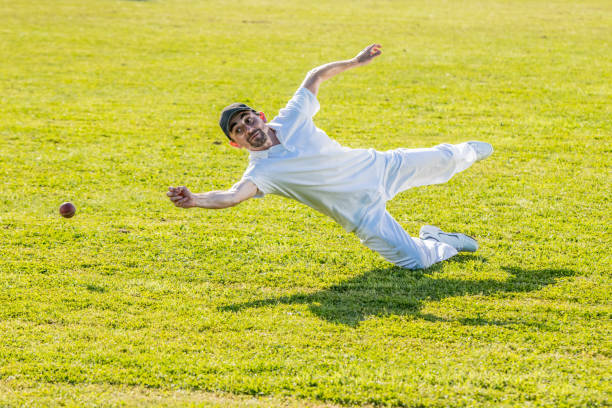 istock Cricket player trying to catch the ball 1202097472