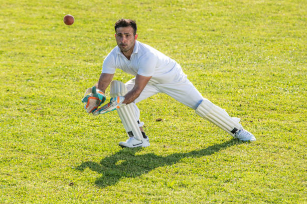 istock Middle-eastern cricket player trying to catch the ball 1202097475