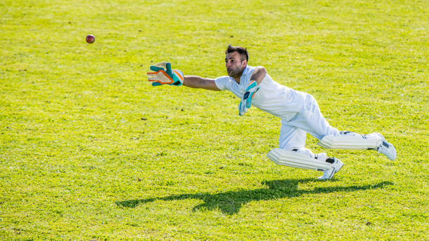 istock Middle-eastern cricket player trying to catch the ball 1202097477