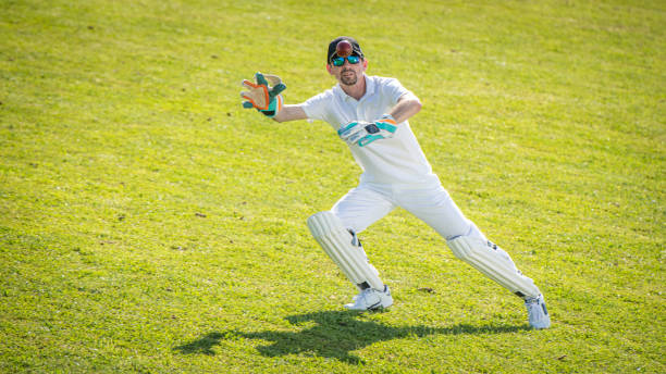istock Cricket player trying to catch the ball 1202097509