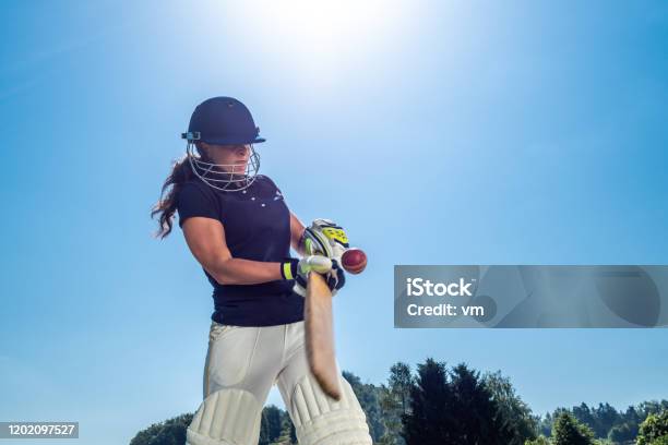 Female Cricket Batter Hitting The Ball Stock Photo - Download Image Now - Sport of Cricket, Women, Cricket Player