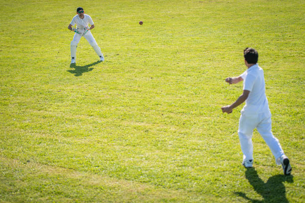 istock Cricket players passing the ball during practice 1202097530