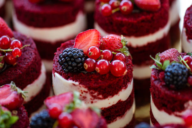 istock Red velvet mini cakes with blackberry close up 1202097652