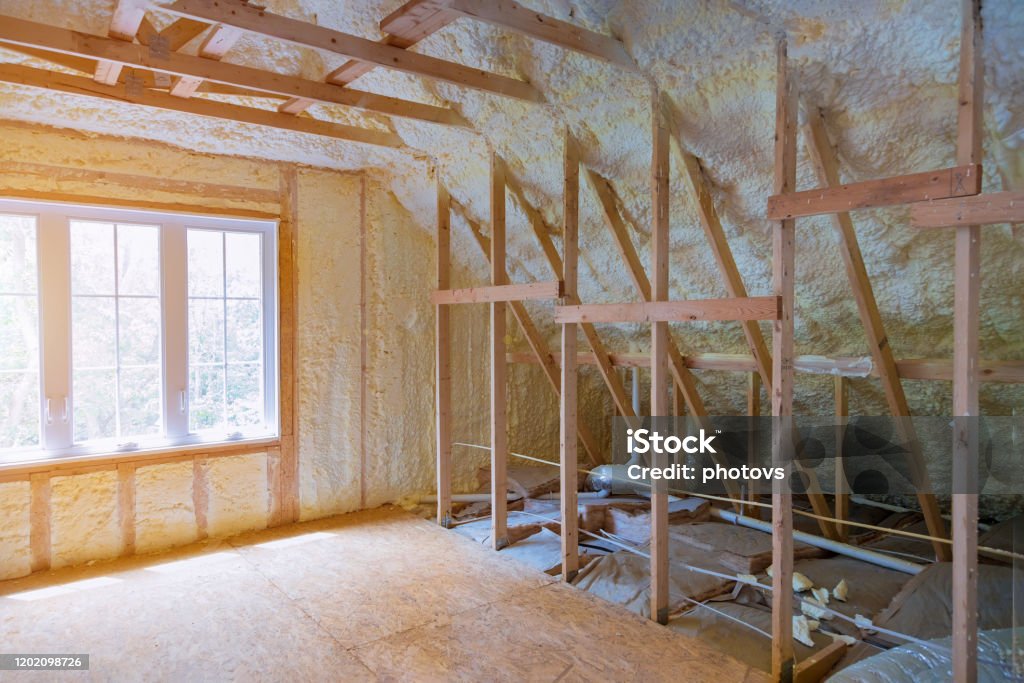 Thermal insulation a new house under the roof of air conditioning on the roof Thermal insulation a new house under the roof of air conditioner vents in new home construction on the roof Insulation Stock Photo