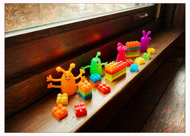 istock Colorful Plastic Toys on Window Sill 1202099867