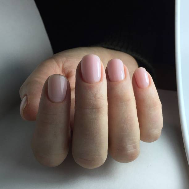 istock Manicure - Beautifully manicured woman's fingernails with nice pink nail polish 1202099985
