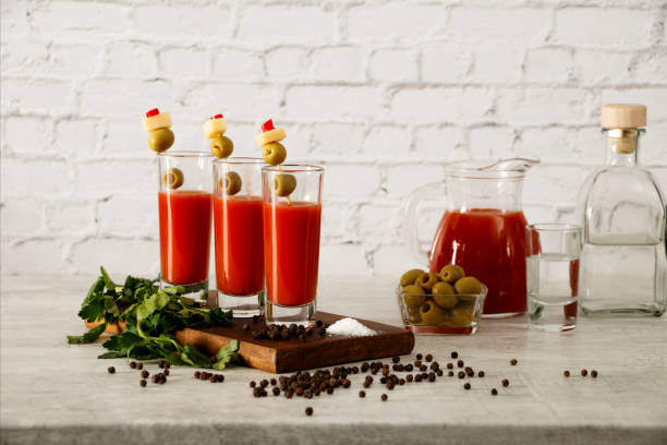 bloody mary cocktail bar z rozmaitymi dodatkami. bloody mary sok pomidorowy z wódką oliwki cytryny i pieprzu na szarym tle. - bloody mary zdjęcia i obrazy z banku zdjęć