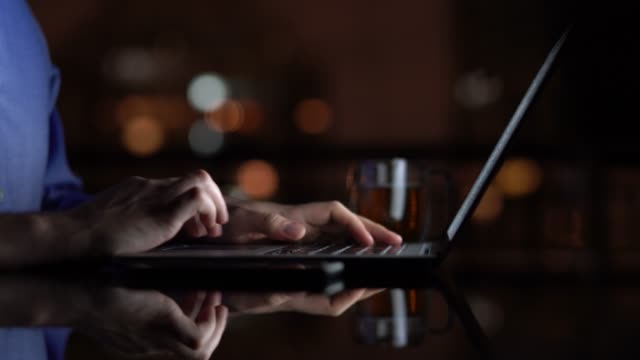 Man working / using laptop at home at night