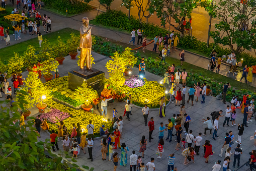 Crowds around a statue of Ho Chi Minh, Nguyen Hue Walking Street during Tet.