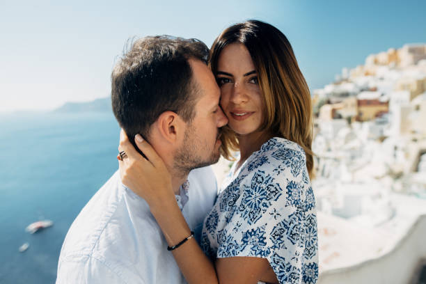istock Couple in sunglasses hugging with seaview 1202102192