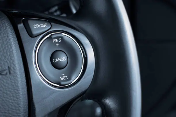 Photo of Cruise control button switch on steering wheel.