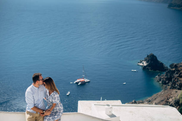 istock Couple in sunglasses hugging with seaview 1202103594