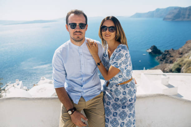 istock Happy couple in sunglasses hugging and smiling 1202103792