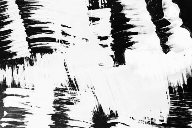 istock Patterns of white paint from a brush on a black background 1202105135