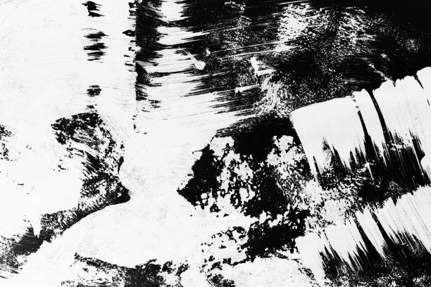 istock Patterns of white paint from a brush on a black background 1202105172