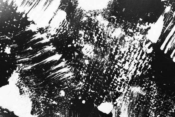 istock Patterns of white paint from a brush on a black background 1202105898
