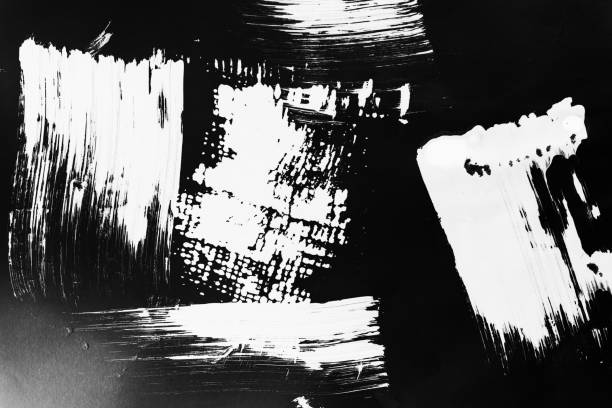 istock Patterns of white paint from a brush on a black background 1202106164