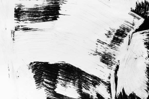 istock Patterns of white paint from a brush on a black background 1202106181