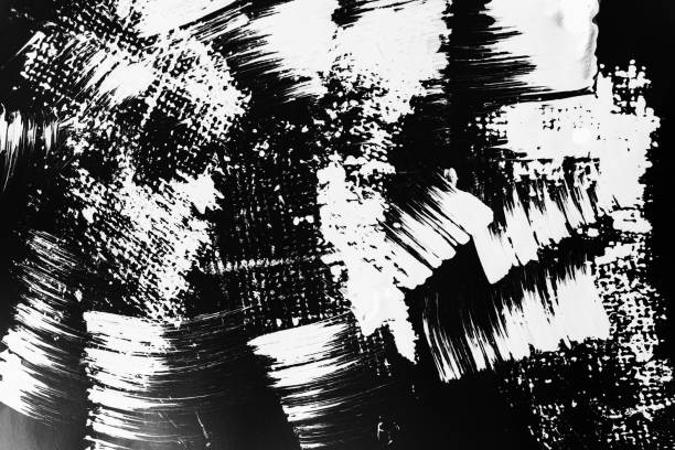 istock Patterns of white paint from a brush on a black background 1202106444