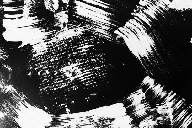istock Patterns of white paint from a brush on a black background 1202106574