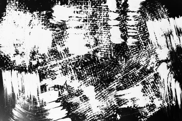 istock Patterns of white paint from a brush on a black background 1202106596