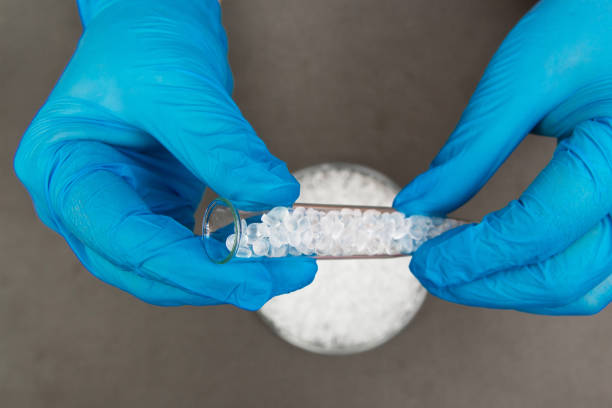 istock Plastic granules . Polyethylene pellets and hands with gloves. Quality control of plastic in the laboratory in production. BPA FREE. 1202108743