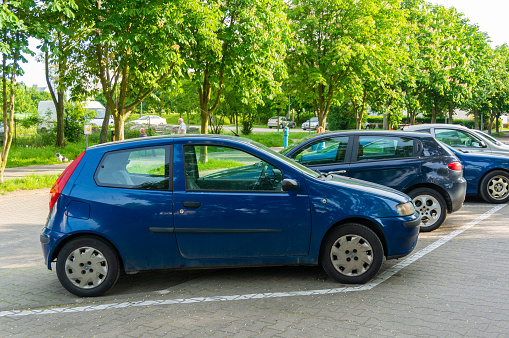 Poznan, Poland - May 24, 2019: Parked blue Fiat Punto car on a parking spot in the city.