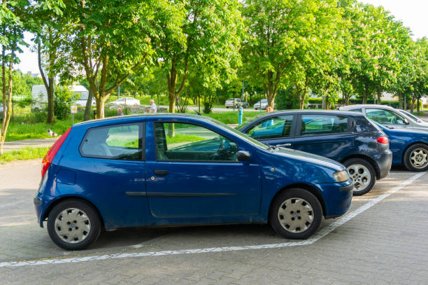 Parked car Poznan, Poland - May 24, 2019: Parked blue Fiat Punto car on a parking spot in the city. punto stock pictures, royalty-free photos & images